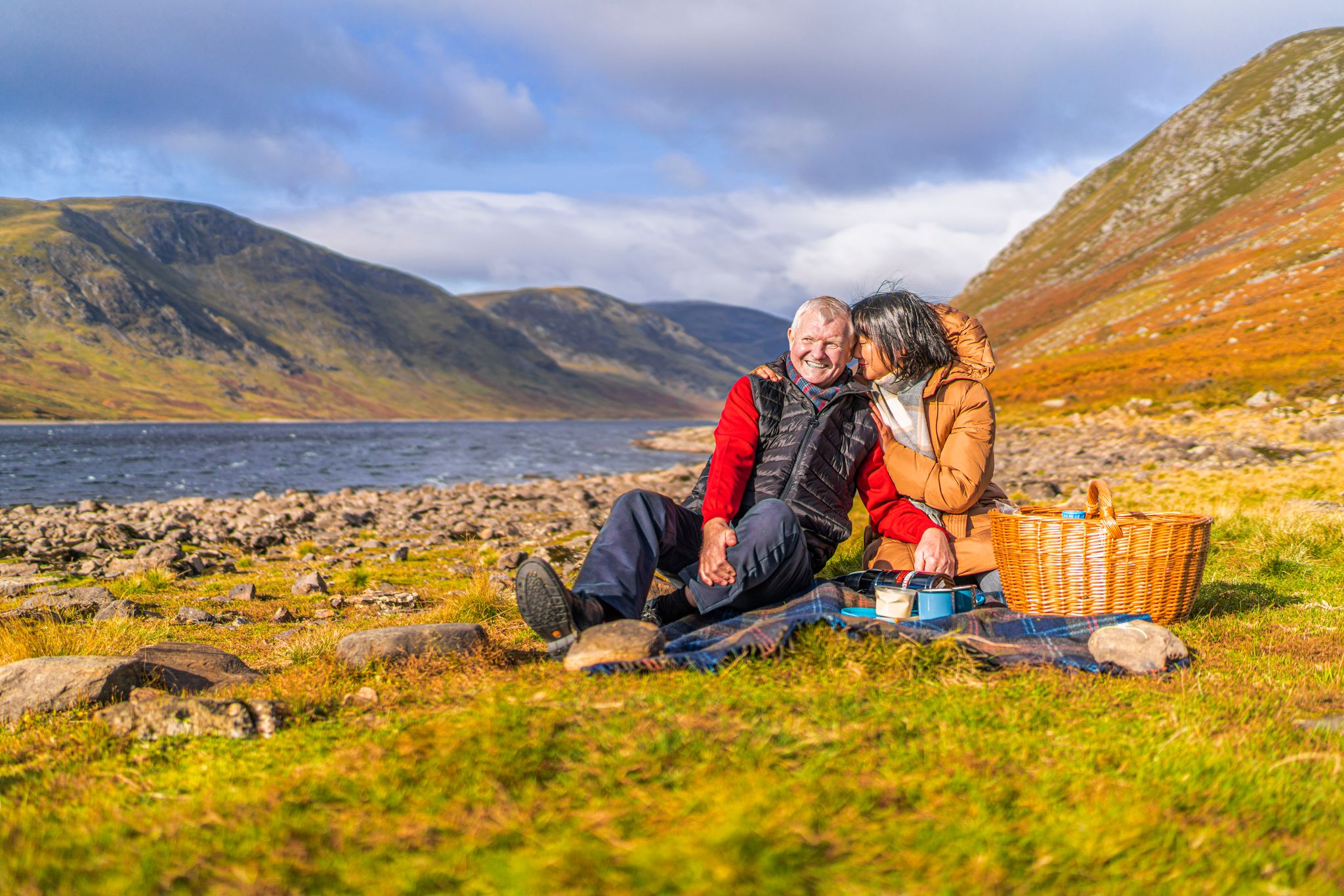 A couple enjoying picnic at Loch Turret